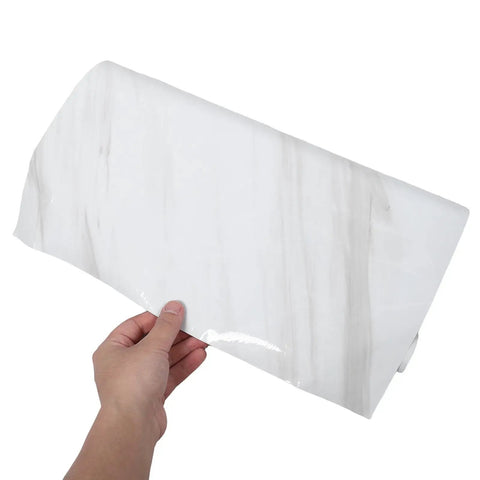 Waterproof Peel And Stick Wallpaper With True Marble Grain For Kitchen Backsplash And Cabinet Makeover Quick Install Oil Resistant Wall Film held in hand.