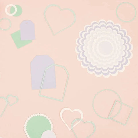 Mini Die Set For Scrapbooking And Card Making - 7 Scalloped Circle Dies, various cut shapes for DIY decorations on a peach surface.