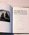 Open book showing title page of 'Work And Mad Wanderings Street Life In The Machine Age Photographic Social History By Ken Appollo'