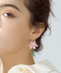 Woman wearing pink lotus earring from Dope Lotus Acrylic Beads Set, 24 Pieces In 7 Styles for DIY jewelry projects