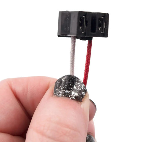 Hand holding wires from Natural Gas Water Heater Pilot Assembly Replacement Kit With Pilot Tube, Thermocouple, Igniter And Hardware