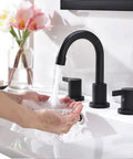 Person using Matte Black Bathroom Sink Faucet With Widespread 8 Inch 3 Hole Vanity Fit, 360 Degree Swivel Spout, Pop Up Drain Included