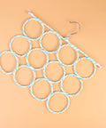 Double Sided Scarf Hanger Closet Organizer Foldable Paper Rattan 12 Ring Tie Holder with blue and white twisted rings.