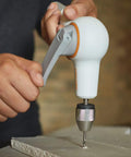 Hand Crank DIY Precision Hand Drill With Soft Grip Foldable Handle For Drywall Wood Laminate Projects in action on drywall.