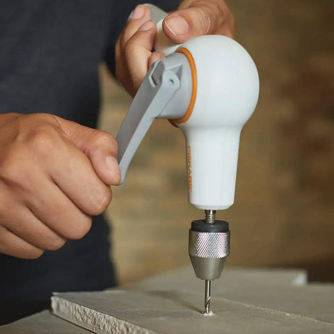 Hand Crank DIY Precision Hand Drill With Soft Grip Foldable Handle For Drywall Wood Laminate Projects in action on drywall.