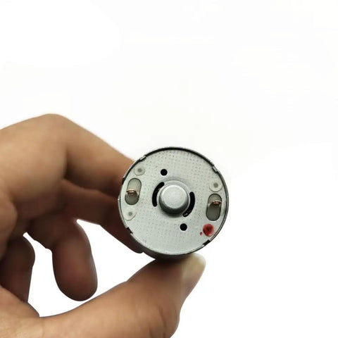 Front view of JGA25-370 Gear Motor 12V DC Low RPM High Torque Micro Gearbox Motor for Robotics held in hand, showing motor face.