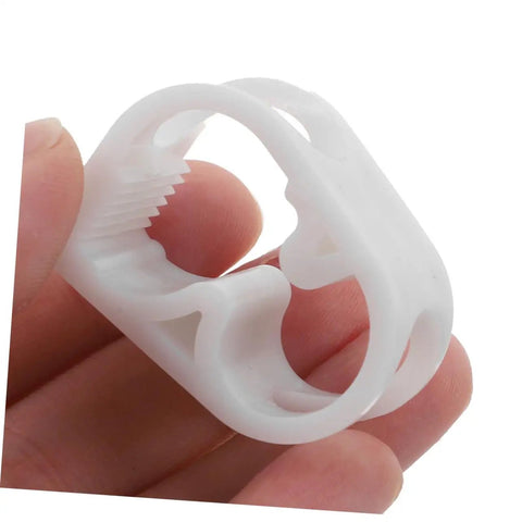 Close-up of a single white plastic clamp from 20 Pieces Flow Control Clamps For Lab Water Hose Tubing Pinch Valves And Tube Clips For Precise Liquid Flow With Adjustable Clamp Set Pro Grade And Flexible Tubing Compatibility, held between fingers for size reference.