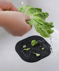 Person rinsing lettuce over Real Deal Silicone Drain Hair Catcher 2 Pack With Grip Secure Suction Cups For Shower Sink Strainer Reusable Bathroom Tub Hair Filter Easy Lift Design Keeps Drains Clear Zero Fuss.