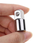 Socket adapter close-up: chrome 3/8-inch head with detent ball, held between fingers.