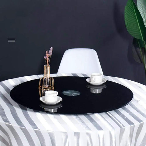 Black Glass Lazy Susan Rotating Turntable on dining table with cups, large serving tray made of tempered 10mm glass, swivel plate for food display.