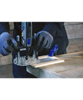 Dremel 335-01 plunger router attachment installed on a rotary tool; clear plastic base.