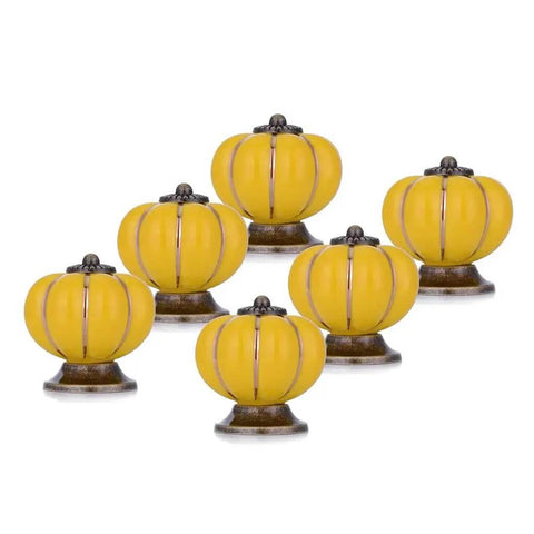 Smooth Yellow Ceramic Cabinet Knobs And Dresser Drawer Handles With Gold Alloy Trim Six Piece Set For Rad Kitchen Cabinet Makeovers And Dope Furniture Upgrades - Set of six yellow ceramic knobs with gold accents.
