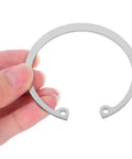 Hand holding Stainless Steel Snap Ring Kit Five Piece C Clips Circlips Retaining Rings for Shafts Pins and Studs, Rust Resistant