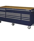Badass 72 Inch Wide Mobile Workbench Tool Chest With Solid Wood Top Integrated Power Strip And 18 Hella Spacious Drawers For Rock Solid Gloss Blue Garage Storage, featuring oak top and multiple drawers.