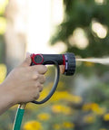 Person using 7 Pattern Watering Nozzle With Thumb Control For Backyard Bosses From Rainlike Shower To Powerful Jet Includes Shower Center Flat Mist Full And Jet Modes Longer Reach Higher Flow Black.