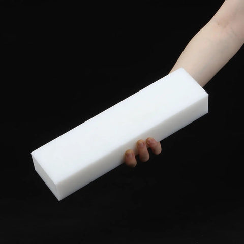 Person holding one Two Pack White HDPE Plastic Blocks For Machining And Prototyping 2 Inch By 3 Inch By 12 Inch Solid Polyethylene Blocks