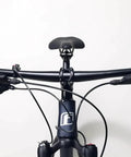 Bike Handlebar Grips Dual Lock-On Clamps, blue ergonomic rubber and aluminum alloy, non slip, on bicycle, front view.