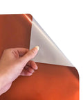 Premium Electric Copper EasyWeed Heat Transfer Vinyl Roll, 11.8 By 3 Feet, shown being peeled for use in custom apparel.