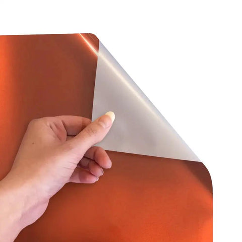 Premium Electric Copper EasyWeed Heat Transfer Vinyl Roll, 11.8 By 3 Feet, shown being peeled for use in custom apparel.