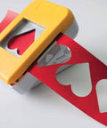 SlimLock Large Oval Punch 40mm By 30mm for Scrapbooking and Card Making cutting red paper hearts with upside-down alignment