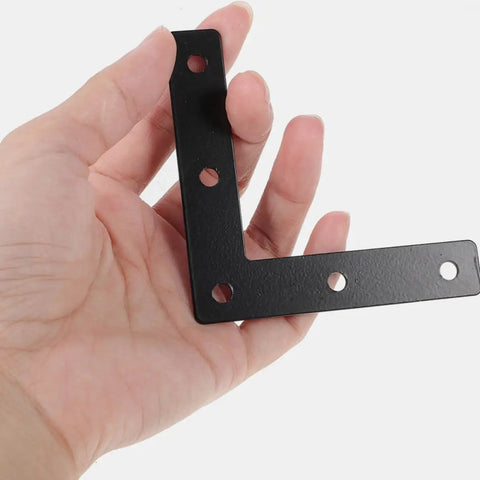Hand holding Rock Solid Heavy Duty Black L Shaped Corner Bracket, Cold Rolled Steel Flat Metal Plate, for Furniture Support