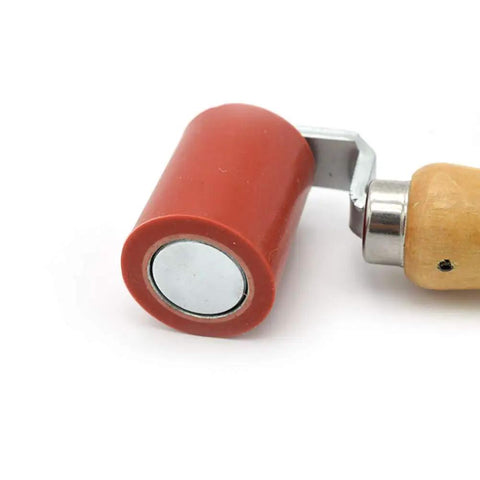 Close-up of a One And Three Quarter Inch Beefy Pro Grade Heavy Duty Silicone Seam Roller with a steel fork and wooden handle for roofing.
