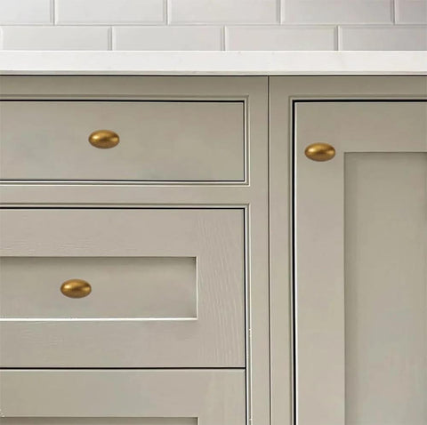 Antique Brass Cabinet Knobs 10 Pack 1-3/8 Inch Oval Drawer Knobs for cabinets and drawers, installed in kitchen setting