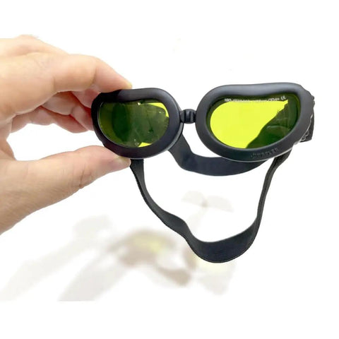 Top Shelf Laser Protection Goggles For Tiny Paws And Furbabies Featuring Anti Glare Uv400 Glass And Rust Proof Frames held in hand.