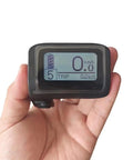 Electric Bike LCD Display Meter DPC11 Cycling Computer CAN Protocol 5 Pin Waterproof Plug held in hand, showing trip data.