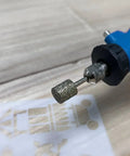 Pro Grade Diamond Grinding Burr Drill Bit Set One Eighth Inch Shank, cylindrical head engraving on wood surface.