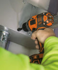 Person using drill with 26-Piece Impact Driver Bit Set With Nut Driver And Screwdriver Bits In Durable Case in construction.