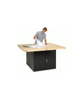 Heavy Duty Shop Workbench With Storage Cabinet Butcher Block Top 64 Inch Wide 54 Inch Deep 33 Inch High in use with blueprints.