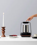 Person using Turkish Coffee Maker Electric With Open Form Design For Watching Foam Rise And Savoring Aroma SandBrew Technology