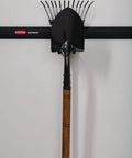 FastTrack Rail Garage Organization System With Multi-Purpose Hooks holding a rake and shovel on a wall-mounted rail