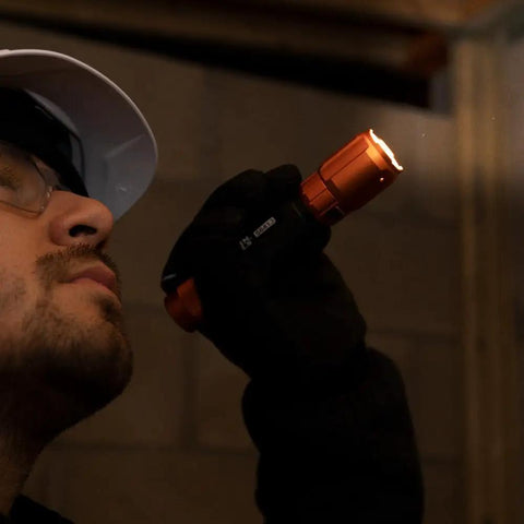 Person using Rechargeable 3 In 1 LED Flashlight With Spotlight Floodlight And Red LEDs 1000 Lumens USB Cable Included for inspection