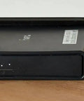 Heavy Duty 19 Inch Rack Mount Bracket For MikroTik Hap AC2 Router displayed on a wooden surface, showcasing secure screw-in hardware.