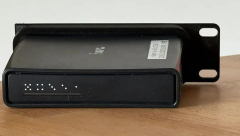 Heavy Duty 19 Inch Rack Mount Bracket For MikroTik Hap AC2 Router displayed on a wooden surface, showcasing secure screw-in hardware.