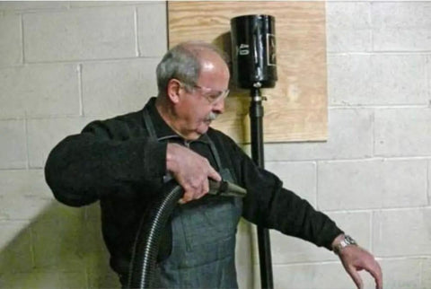 Man using Industrial Air Blaster For Quick Kickin It Clean Cleanup Of Clothes Surfaces Electronics And Car Interiors With High Volume