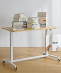 Electric Sit Stand Desk Offering Smooth Height Adjustment, Mobile Rolling Computer Workstation For Home Office with stacked books.