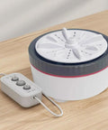 No Sweat Portable Mini Turbo Washing Machine With Steady Grip Base For Daily Baby Laundry And Underwear Lightweight Micro Usb Rechargeable Compact Countertop Cleaner on a wooden surface with control panel.