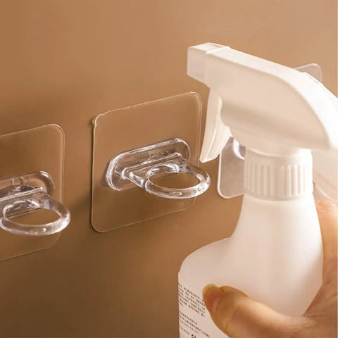 Heavy Duty Adhesive Wall Hooks 30 Pack Straight Up No Drill Setup For Bathroom Kitchen Storage Waterproof Plastic holding a spray bottle.
