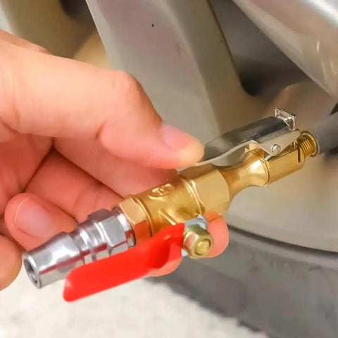 Hand holding a heavy duty metal Straight Up Slick Lock On Tire Inflator Chuck with red quick release valve for vehicle tire inflation.