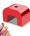 Front view of red cast horseshoe magnet for nails; arch-shaped with top hole; two small magnets held in hand.