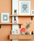 Legit Heavy Duty Folding Shelf Brackets Solid Steel Wall Mounted Space Saver with shelves displaying decor and plants.