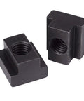Two black oxide T slot nuts with threaded holes in focus, part of Four Piece T Slot Nut Set Black Oxide Finish With Three Eighths Inch By Sixteen Threads For Half Inch Table Slot Size Fits Milling Machines And Tooling Made From 1018 Steel Beefy Nut Set For DIY Metalworking.