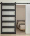 Front view of 48 Inch By 84 Inch 5 Lite Tempered Frosted Glass Sliding Barn Door With Black Finish Composite Interior Hardware Kit And Rail System Left Or Right Mount Easy Assembly Dope Modern Farmhouse Vibe installed in bedroom.