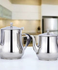 Two stainless steel teapots on a kitchen counter, including a Mini 360Ml Stainless Steel Teapot For Tea And More, Ultra Compact Yet Sturdy.