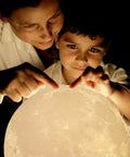 Child and adult using 3D Printed Moon Lamp Night Light With Touch Control, USB Rechargeable, Adjustable Brightness In Warm White
