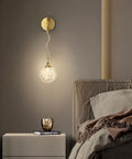 Top Shelf High Quality Brushed Brass Wall Sconce Paired With Frosted Glass Globe Led Bathroom And Bedroom Vanity Light Adjust Your Space With This Durable Fixture on a beige wall.