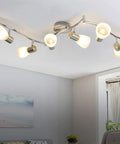 Six-Light Flexible Track Lighting Rail With Glass Shade LED Spot Ceiling Lights, Brushed Steel Finish in a modern living room.